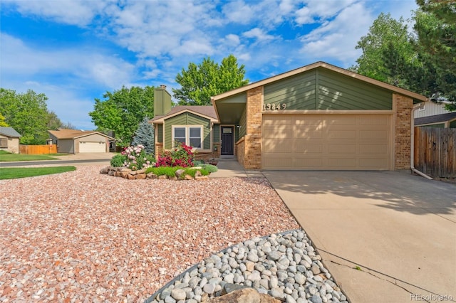 13849 W 66th Dr, Arvada, CO 80004 - mid-century home with brick siding, driveway, an attached garage, and a chimney