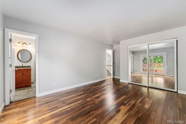 13849 W 66th Dr, Arvada, CO 80004 - unfurnished bedroom featuring wood finished floors, a closet, and ensuite bathroom