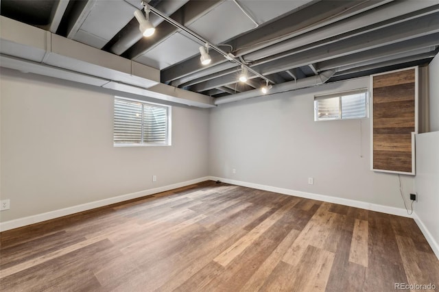 13849 W 66th Dr, Arvada, CO 80004 - basement featuring wood finished floors, plenty of natural light, and track lighting