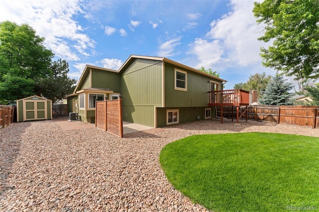 13849 W 66th Dr, Arvada, CO 80004 - rear view of property with a fenced backyard, a storage shed, and a deck