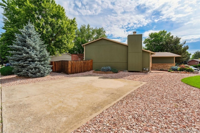 13849 W 66th Dr, Arvada, CO 80004 - view of side of home with a chimney
