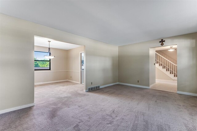 10851 E Iliff Pl, Aurora, CO 80014 - carpeted empty room featuring stairway and baseboards