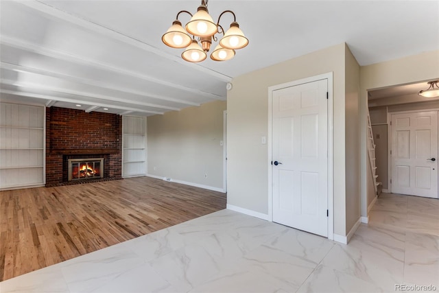 10851 E Iliff Pl, Aurora, CO 80014 - unfurnished living room with a chandelier, marble finish floors, beam ceiling, a brick fireplace, and built in features