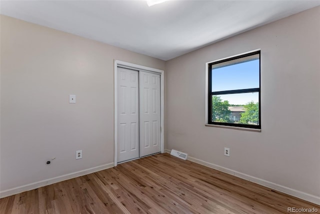 10851 E Iliff Pl, Aurora, CO 80014 - unfurnished bedroom featuring light wood-style floors and a closet
