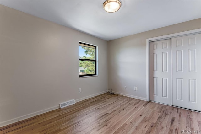 10851 E Iliff Pl, Aurora, CO 80014 - unfurnished bedroom featuring light wood finished floors and a closet