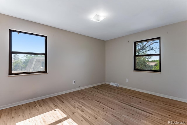 10851 E Iliff Pl, Aurora, CO 80014 - empty room featuring baseboards and light wood-type flooring
