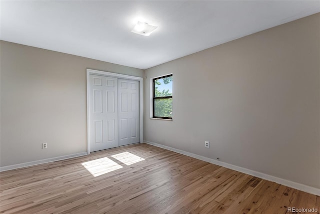 10851 E Iliff Pl, Aurora, CO 80014 - unfurnished bedroom with light wood-style floors and a closet