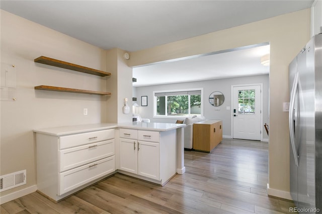5280 S Logan St, Littleton, CO 80121 - kitchen featuring freestanding refrigerator, light wood-type flooring, white cabinets, light countertops, and open floor plan