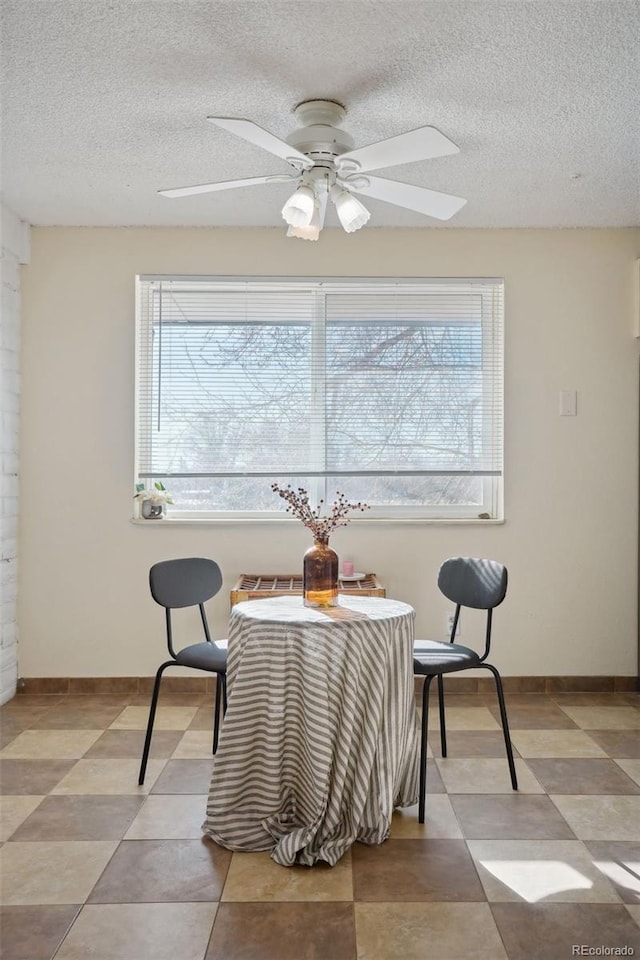 sitting room featuring ceiling fan and a textured ceiling