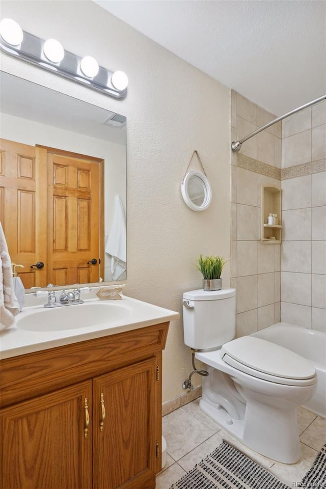 bathroom with tile patterned floors, vanity, and toilet