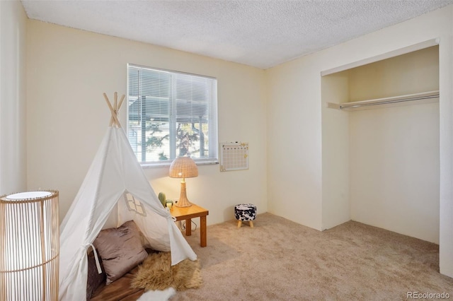 interior space featuring a textured ceiling and a closet