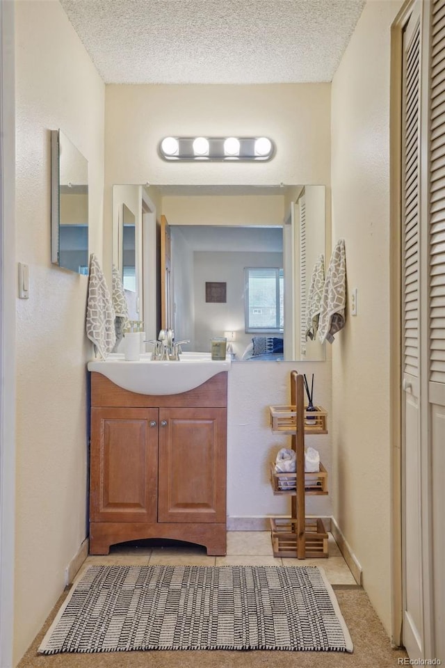 bathroom with vanity and a textured ceiling