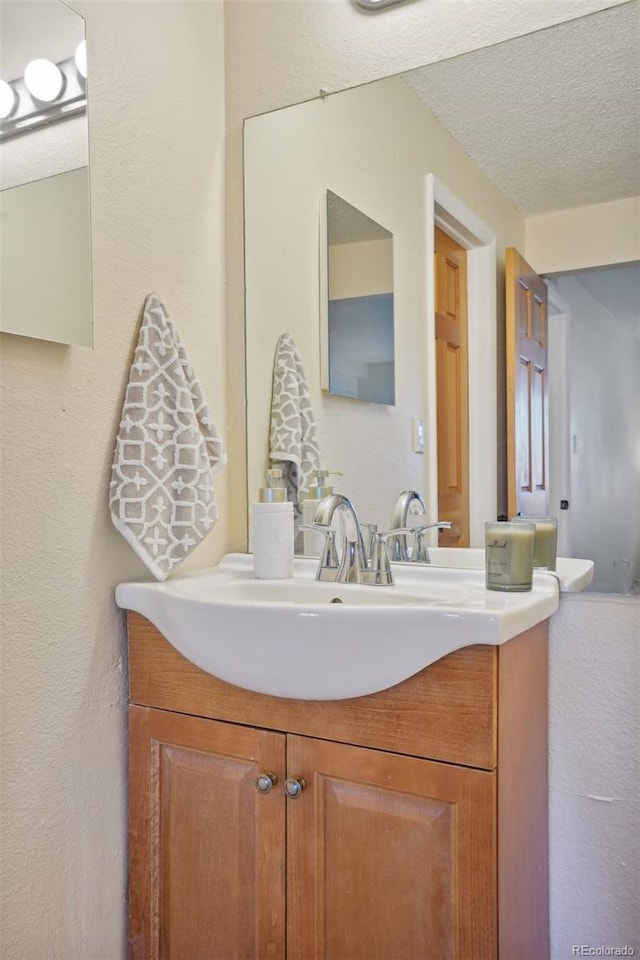 bathroom featuring vanity and a textured ceiling