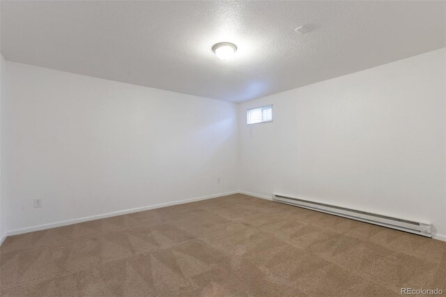 3577 S Ouray Cir, Aurora, CO 80013 - carpeted spare room with a baseboard heating unit and a textured ceiling