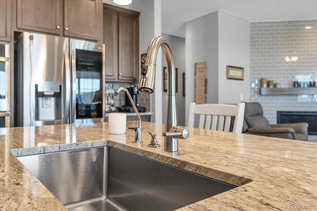 23913 E Swallow Cir, Aurora, CO 80016 - kitchen featuring stainless steel fridge with ice dispenser and light stone countertops