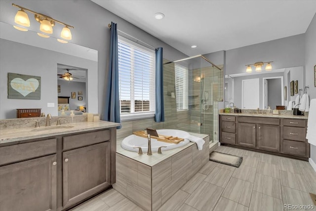 23913 E Swallow Cir, Aurora, CO 80016 - full bath with a stall shower, two vanities, a bath, ceiling fan, and tile patterned flooring
