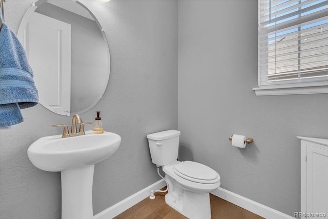 23913 E Swallow Cir, Aurora, CO 80016 - half bathroom with healthy amount of natural light and wood finished floors