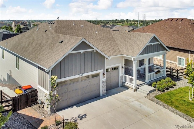 23913 E Swallow Cir, Aurora, CO 80016 - view of front facade with board and batten siding, stone siding, and a shingled roof