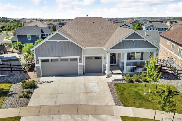 23913 E Swallow Cir, Aurora, CO 80016 - view of front of property featuring board and batten siding, an attached garage, concrete driveway, a porch, and a shingled roof