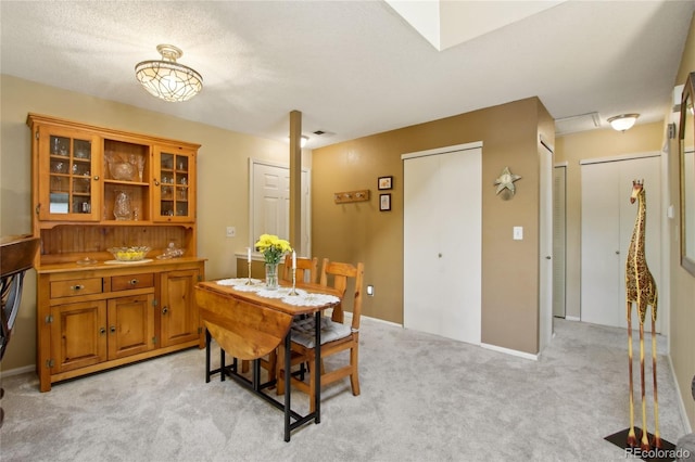 dining room with light carpet