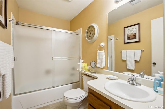 bathroom featuring toilet, vanity, and shower / bath combination with glass door