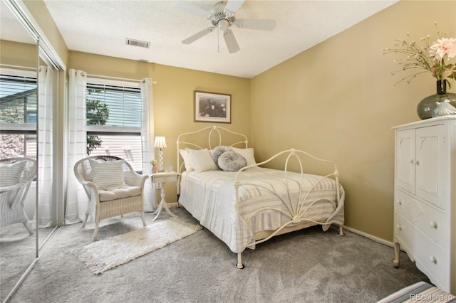 carpeted bedroom featuring ceiling fan and baseboards
