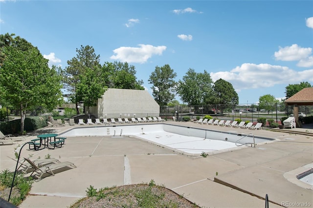 community pool featuring a patio and fence