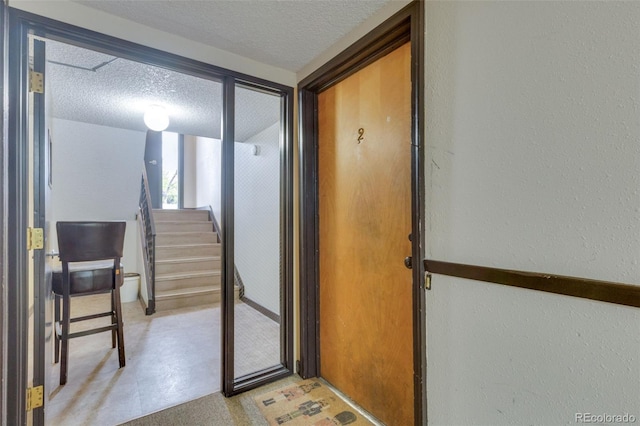 1611 Garfield Ave Unit 2, Louisville, CO 80027 - hallway featuring a textured ceiling, a textured wall, stairs, and light floors
