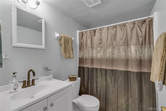 1611 Garfield Ave Unit 2, Louisville, CO 80027 - bathroom featuring a textured ceiling, toilet, vanity, and a shower with curtain