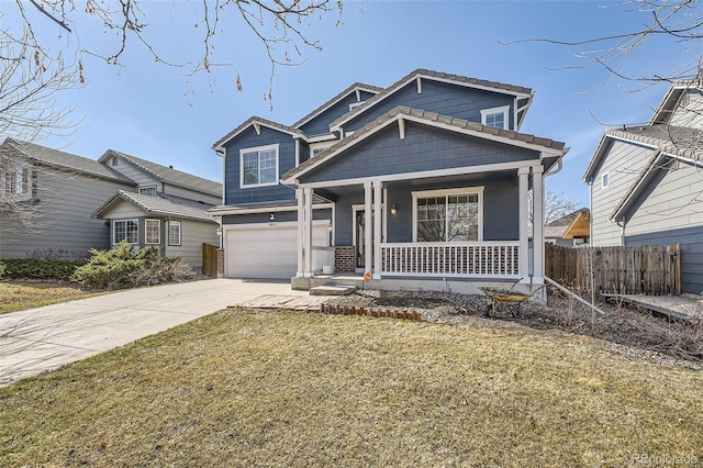 view of front of house with a front lawn, driveway, a porch, fence, and an attached garage