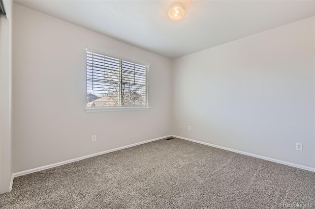 empty room with baseboards and carpet flooring