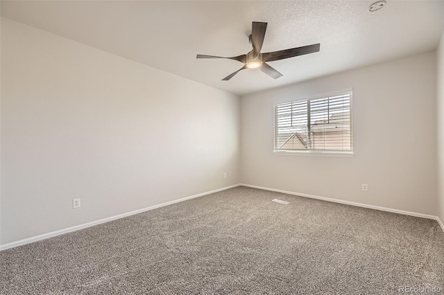 unfurnished room featuring baseboards, a ceiling fan, and carpet floors