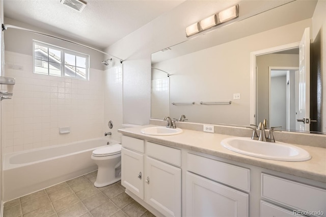 full bathroom with a sink, visible vents, toilet, and shower / bath combination