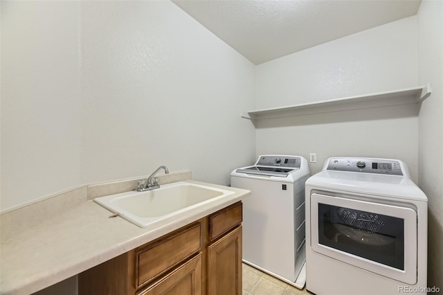 laundry room with a sink, cabinet space, and washer and dryer