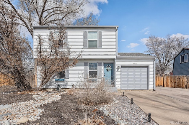 view of front of home featuring a garage, driveway, and fence