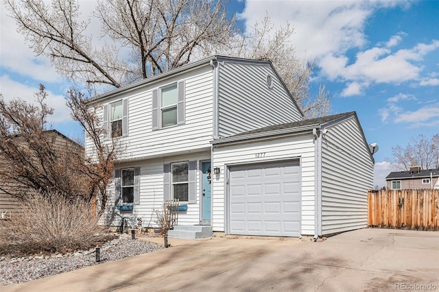 view of front of property with a garage, driveway, and fence