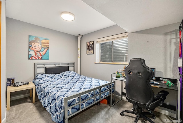 bedroom featuring carpet floors and baseboards