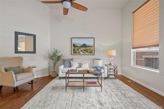 living room with hardwood / wood-style flooring and ceiling fan