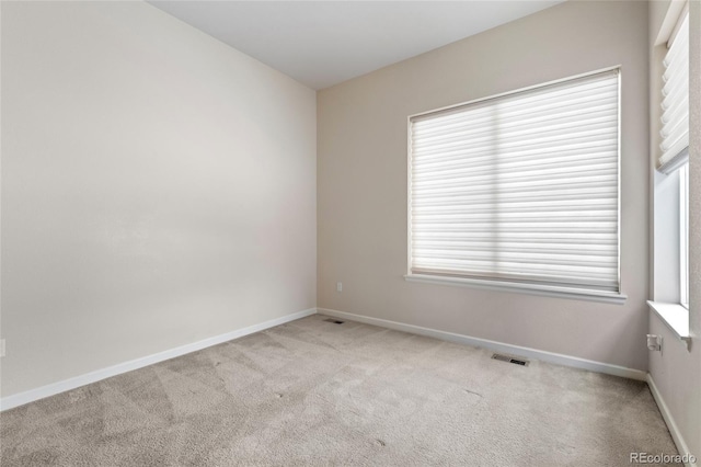 empty room featuring light carpet