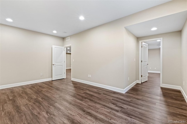 unfurnished room with dark hardwood / wood-style flooring