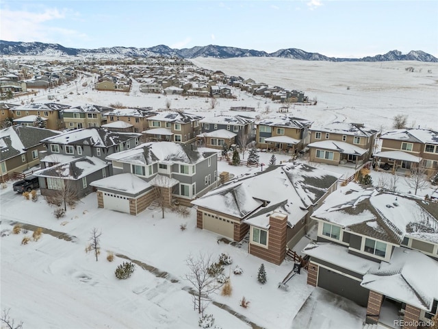 snowy aerial view featuring a mountain view