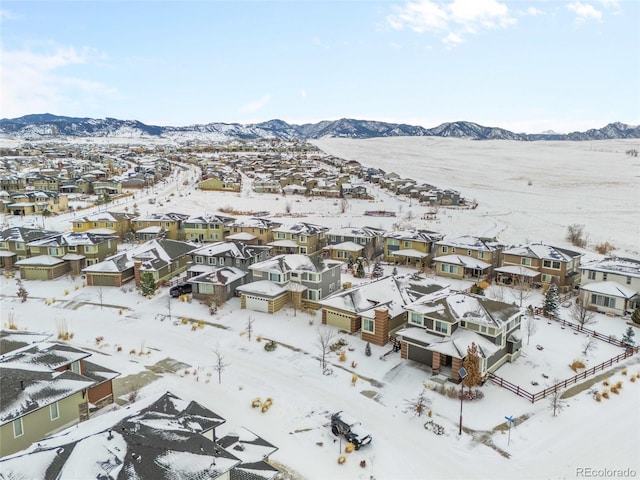 snowy aerial view with a mountain view