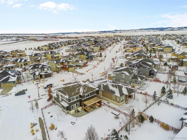 snowy aerial view with a mountain view