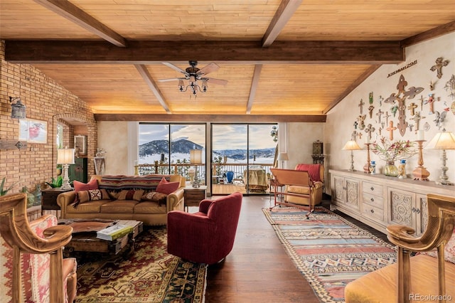 living room with brick wall, vaulted ceiling with beams, wooden ceiling, wood finished floors, and a mountain view