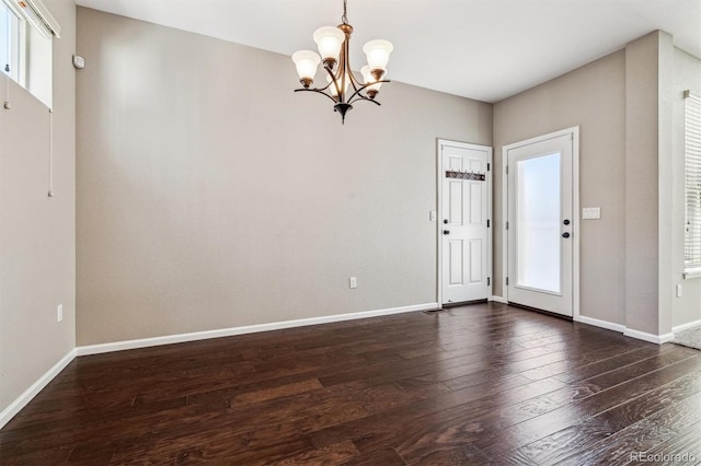 foyer featuring a healthy amount of sunlight, dark hardwood / wood-style floors, and a chandelier