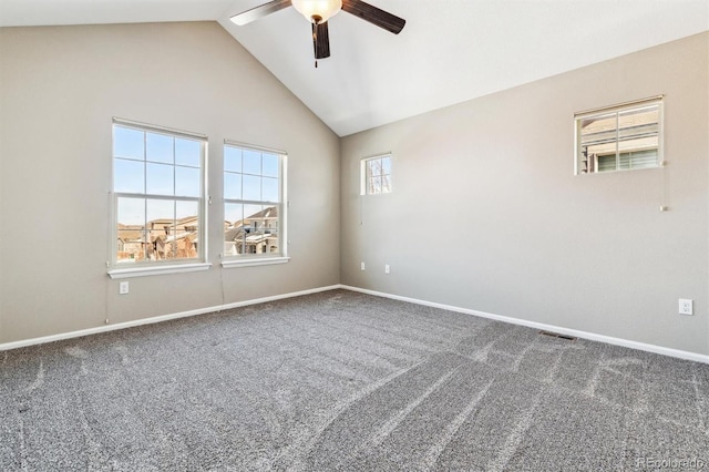 unfurnished room with ceiling fan, lofted ceiling, and dark carpet