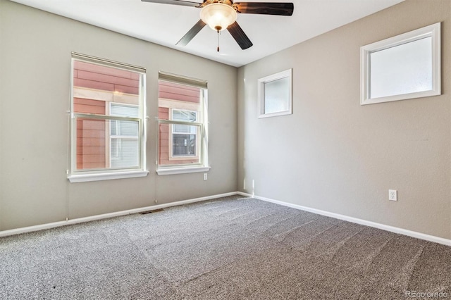 carpeted spare room featuring ceiling fan