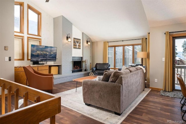 living room featuring a fireplace, high vaulted ceiling, dark hardwood / wood-style floors, and a healthy amount of sunlight