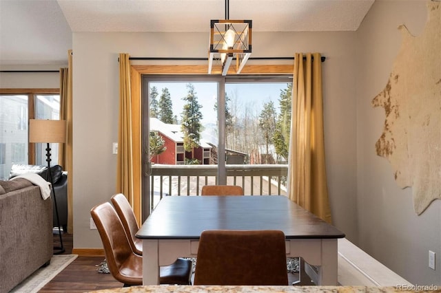 dining room with a textured ceiling, hardwood / wood-style flooring, and plenty of natural light