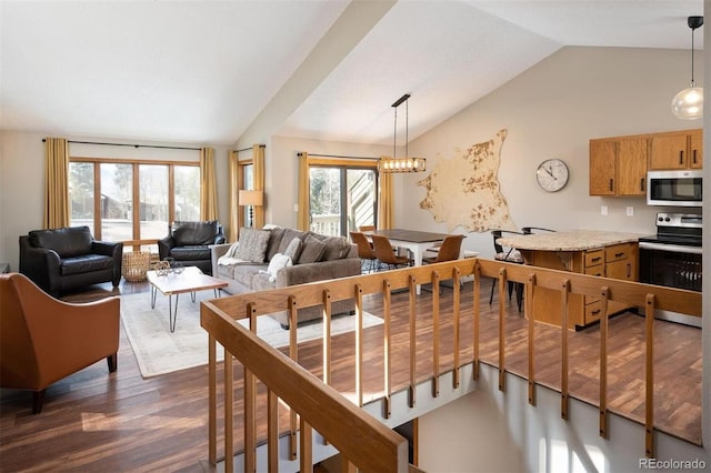 living room with dark wood-type flooring, vaulted ceiling, and a notable chandelier